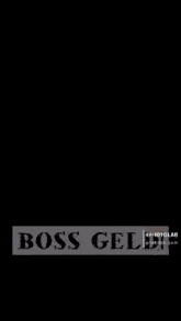 a man in a white shirt and white pants is standing in front of a boat with the words boss gel written on it
