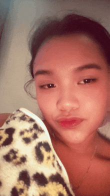 a woman with a leopard print blanket on her shoulders