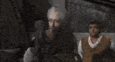 a man singing and i go my merry way while another man looks on