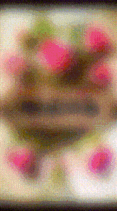 a blurry picture of flowers on a table with a black border