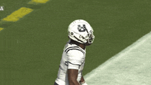 a football player wearing a white helmet and number 1 jersey is running on a field .