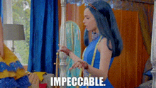 a woman in a blue dress is standing in a room with the words impeccable written on the screen .