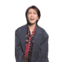 a woman in a suit and tie is smiling with her eyes closed