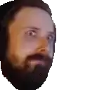 a man with a beard and headphones is looking at the camera .