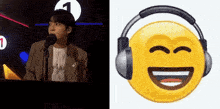 a man is singing into a microphone next to a smiley face with headphones on .