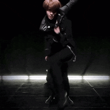 two men are dancing in a dark room and one has a badge on his jacket that says ' police '
