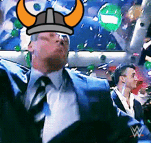 a man in a suit and tie with a viking helmet on his head