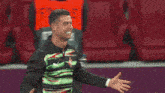 a man covering his face with his hand while another man holds his arm around him
