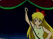 a girl with blonde hair and a red bow on her head is pointing