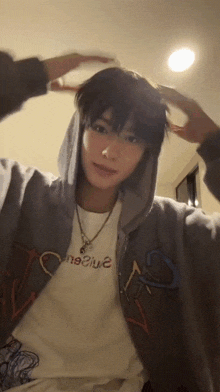 a young man wearing a hoodie and a t-shirt that says " negative "