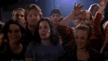 a woman in a bc 110 shirt stands in a crowd