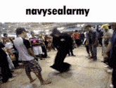 a group of people are dancing in front of a sign that says navysealarmy