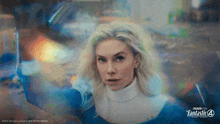 a woman in a fantastic 4 costume is holding a sword