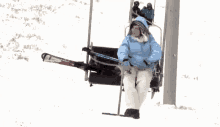 a woman is riding a ski lift with a pair of skis on the back