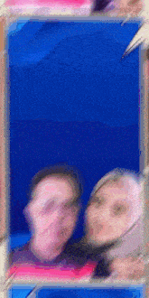 a blurry picture of a man and a woman standing next to each other