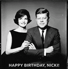 a black and white photo of a man and woman posing for a picture .