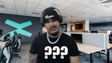 a man wearing headphones and a t-shirt that says " ?? "