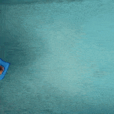 a person floating in a pool with a tray of food on it