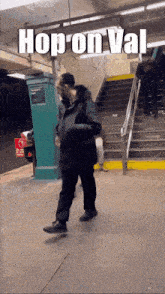 a man walking down stairs with the words hop on val written above him
