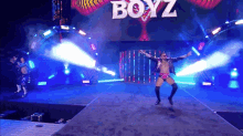 a wrestler is walking down a ramp with the word boyz on it
