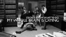 a black and white photo of a man laying on the floor