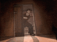 a man is standing in a doorway looking out