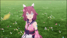 a girl in a pink dress is standing in a field with confetti falling around her