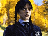 a girl with braids wearing a school uniform with the letters nc on her chest