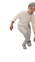 a man wearing a hat and a white shirt is standing on one leg
