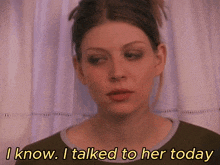 a woman says i know i talked to her today in front of a curtain