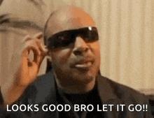 a man wearing sunglasses is talking on a cell phone and says `` looks good bro let it go ! ''