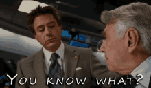 a man in a suit and tie talks to another man with the words " you know what " written below them