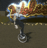 a girl is riding a unicycle in front of a sign that says " welcome "