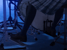 a person playing a drum set with their foot on the pedal