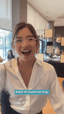 a woman wearing glasses and a white shirt says " aiah "