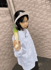 a person wearing a helmet and holding a bunch of greens