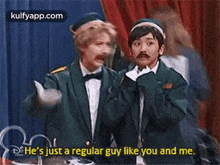 two men are standing next to each other on a stage and one of them is talking about a regular guy like you and me