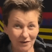 a close up of a woman 's face with a serious look on her face .