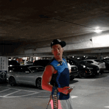 a man standing in a parking garage wearing a shirt that says ' stealth ' on the side