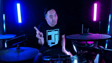 a man wearing a t-shirt with the letter j on it