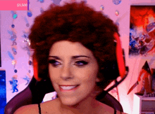 a woman wearing a wig and headphones is smiling in front of a screen that says $ 1.500