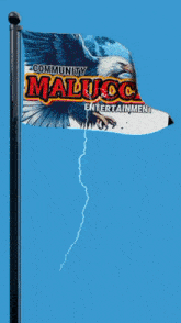 a flag that says community malucca entertainment flies in the wind
