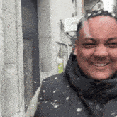 a man in a black jacket is smiling in front of a white sign that says ebay