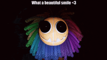 a picture of a colorful stuffed animal with the caption " what a beautiful smile < 3 "