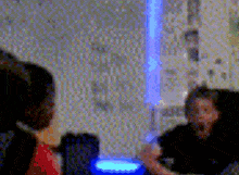 a blurry picture of two people talking in front of a window