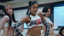 a woman wearing a crop top that says ' i love you ' on it