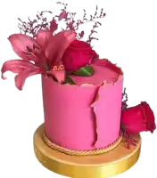 a pink cake with roses and a lily on top has the letters ac on it