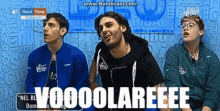 a group of people are sitting in front of a wall with the words voooolareeee on it