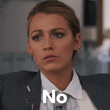 a woman in a suit and tie has the word no written on her face