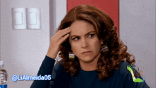 a woman scratches her head with the hashtag lialmeida05 on the bottom
